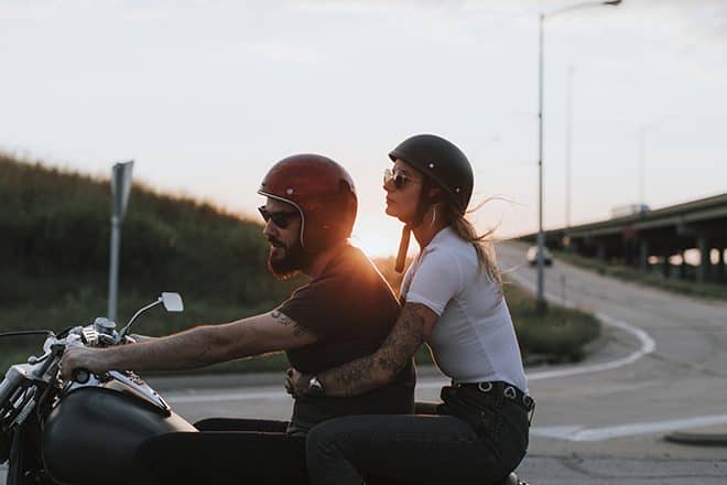 Motorcyclists at sunset man and woman