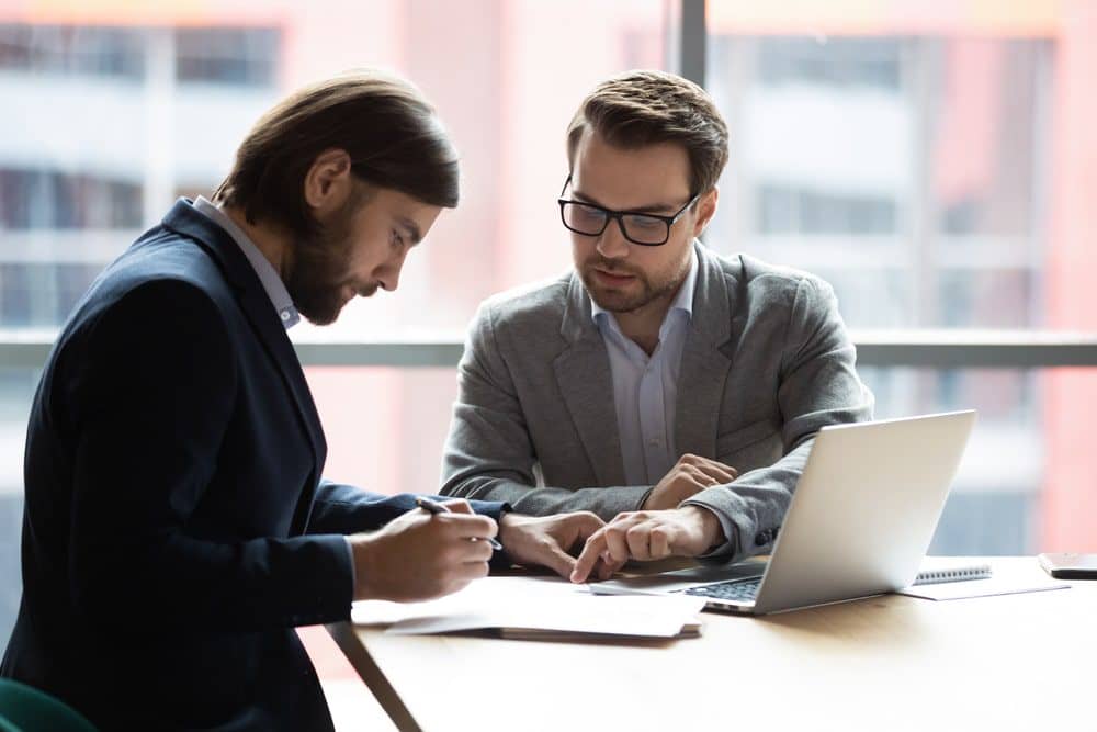 Photo of two man at the table