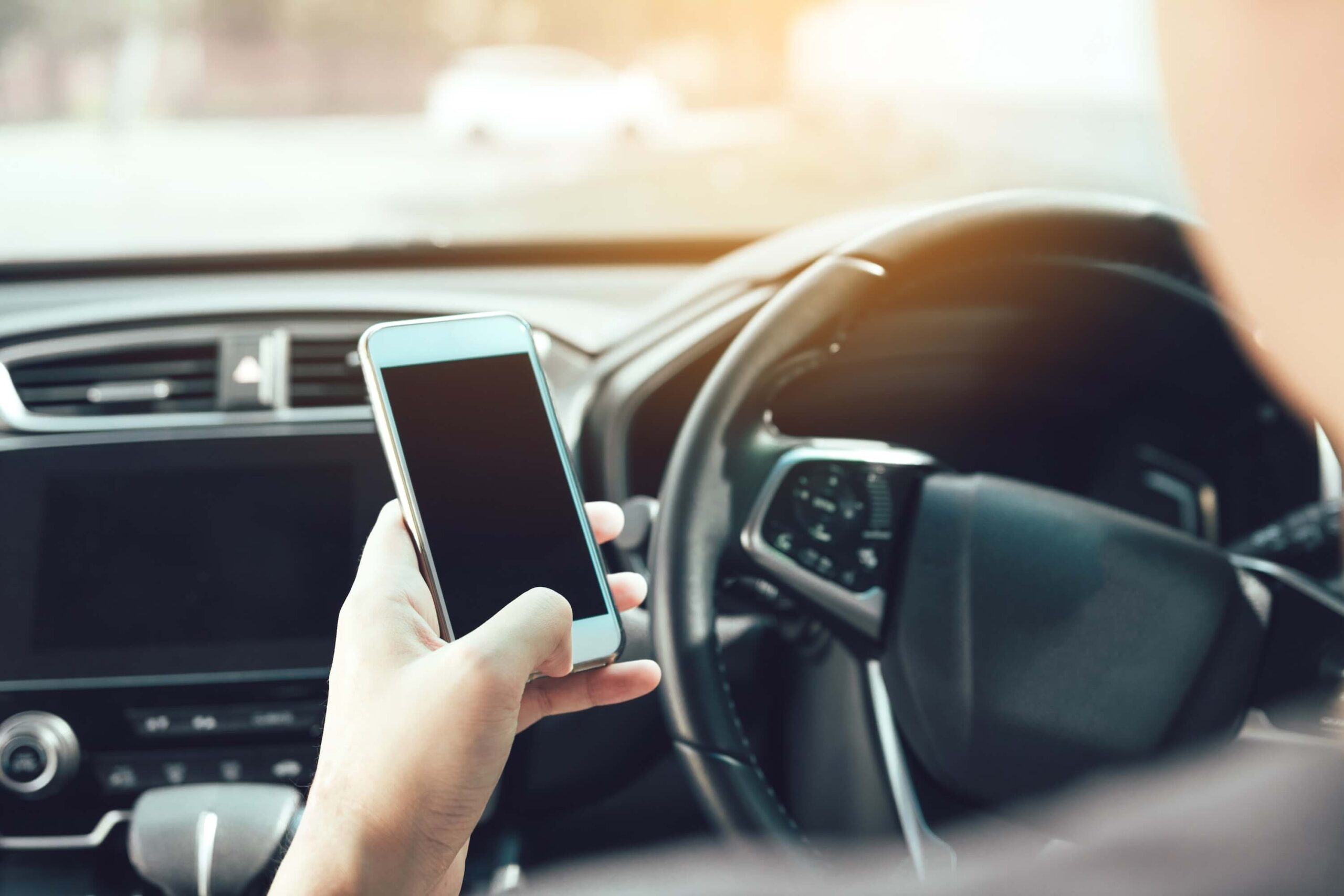 Man using phone while driving