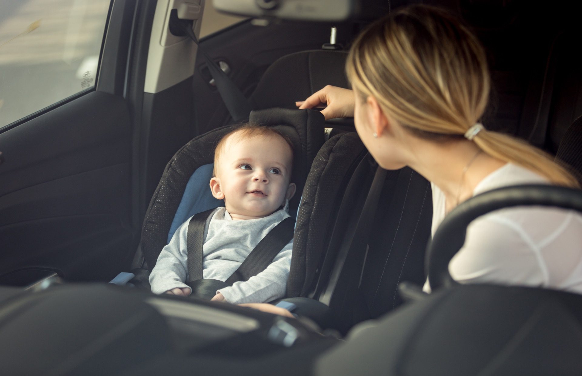 Mother is comforting child in the car